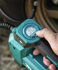 Makita DMP181ZX 18V cordless high-pressure inflator, teal plastic housing, close-up of gauge and trigger.