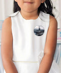 Child wearing 12 Pack 2.4 Inch Round Button Pins Set Made From Durable Tinplate Metal With Custom Photo Prints on white dress