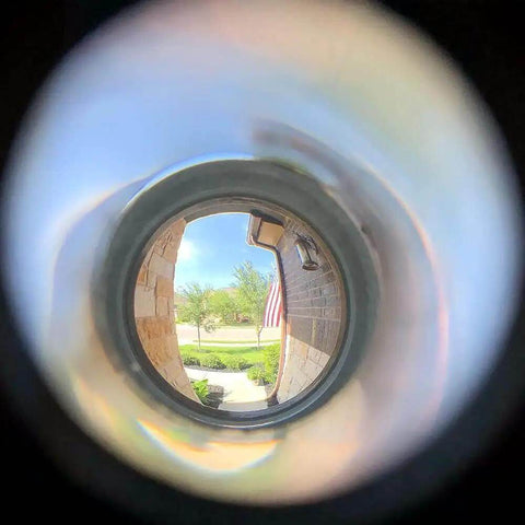 View through Solid Brass 220-Degree Door Viewer Peephole With Heavy Duty Rotating Privacy Cover, illustrating ultra wide HD lens clarity.