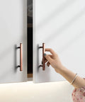Person opening cabinet with Six Pack 3 Inch Hole Center Antique Copper Zinc Alloy Cabinet Pulls For Kitchen Drawers 4.73 Inch Length