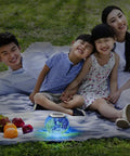 Family enjoying picnic with Color Changing Mosaic Solar Glass Globe Light For Garden Patio Yard waterproof LED ball nearby.