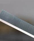 Close-up view of a Pro Grade 12 Inch Planer Blade, HSS steel, precision ground for woodworking tools, sharp edge detail.