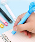 Smooth As Butter Pen Style Correction Tape Rollers With Zero Stink And Zero Drama Glide in blue color, held while correcting notes.