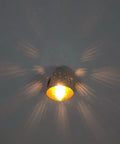 Silver Brass Wall Sconce, Mid Century Cone Lamp, Perforated Spotlight casting unique light patterns on wall.