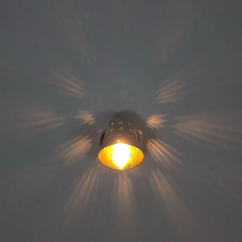 Silver Brass Wall Sconce, Mid Century Cone Lamp, Perforated Spotlight casting unique light patterns on wall.