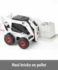 Bobcat Skid Steer Construction Toy Set 1:32 Die Cast With 15 Piece Playset And 3 Interchangeable Attachments Bucket Backhoe Fork Ages 3 Plus Realistic On Site Role Play with fork attachment carrying bricks.