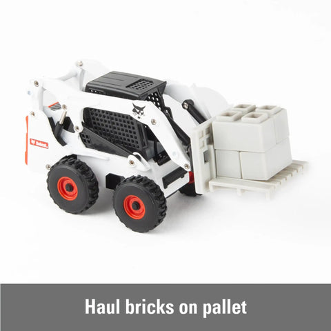 Bobcat Skid Steer Construction Toy Set 1:32 Die Cast With 15 Piece Playset And 3 Interchangeable Attachments Bucket Backhoe Fork Ages 3 Plus Realistic On Site Role Play with fork attachment carrying bricks.