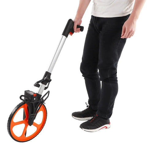 Pissente Hand Measuring Wheel, 0-9999.9ft Mechanical Counter held by a person, showcasing lightweight alloy and ergonomic design.