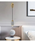 Premium Copper Wall Sconce Featuring Sparkling Crystal Accent Shades With Soothing Warm Led Glow, hung beside a modern bed.