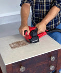 Man using Heavy Duty 110V 4 Amp All Purpose Sander Grinder Buff Polisher With Pistol Grip on wooden furniture top