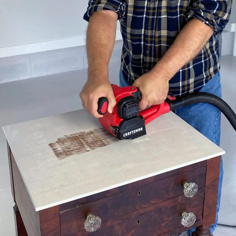 Man using Heavy Duty 110V 4 Amp All Purpose Sander Grinder Buff Polisher With Pistol Grip on wooden furniture top