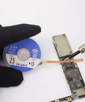 Gloved hand using Premium Copper Solder Wick Set 1.5mm To 3.5mm Width Desoldering Braid Wire on circuit board for precise repair.