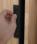 Black self-adhesive edge fingerpull door handle set installed on wood, part of the Self-Adhesive Edge Fingerpull Door Handle Set 2 Pack Black