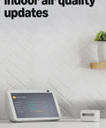 Slick Indoor Air Quality Monitor Tracks Temp Humidity Carbon Monoxide Pm2.5 Vocs Hooks Into Alexa Sends Snappy Alerts to Keep Your Home Breezy And Pretty Much Fume Free on countertop next to smart display.