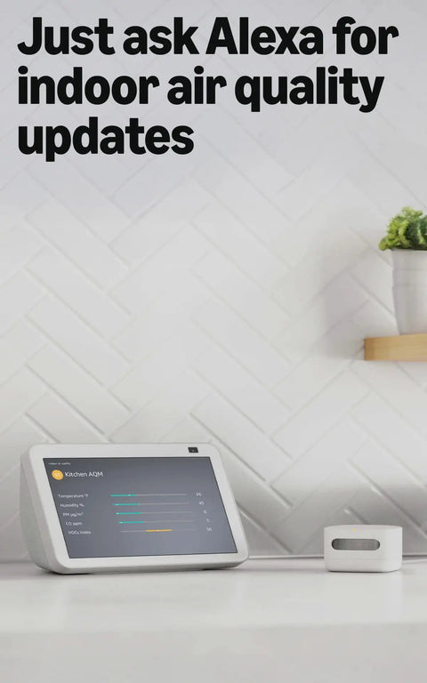 Slick Indoor Air Quality Monitor Tracks Temp Humidity Carbon Monoxide Pm2.5 Vocs Hooks Into Alexa Sends Snappy Alerts to Keep Your Home Breezy And Pretty Much Fume Free on countertop next to smart display.
