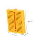 Hella Handy Six Piece Solderless Breadboard Kit in yellow, compact for circuit prototyping, measures 1.9in x 1.4in x 0.4in.