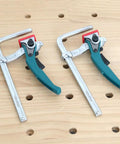 Badass Quick Release Track Saw Clamp Pair Featuring Ratchet Guide Rail Adapter For Mft Tables positioned on a workbench.