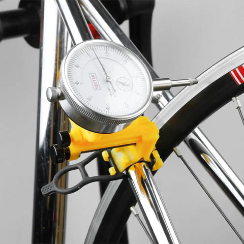 Pro Grade Bike Wheel Truing Stand With Precision Percentage Table for accurate spoke position, yellow tool on bike rim