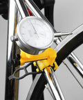 Pro Grade Bike Wheel Truing Stand With Precision Percentage Table for Accurate Spoke Position, yellow, in use for rim adjustment