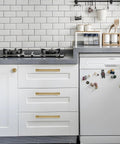 Gold Cabinet Knobs Set 10 Pack Round 1 Inch Brushed Brass Zinc Alloy Dresser Knobs installed on white kitchen cabinets.