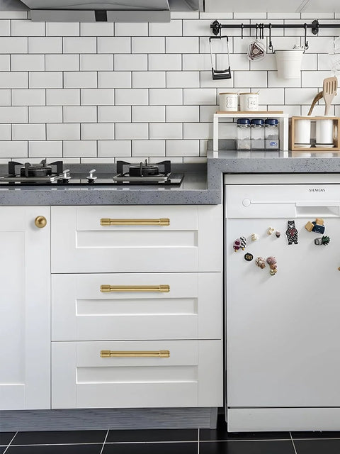 Gold Cabinet Knobs Set 10 Pack Round 1 Inch Brushed Brass Zinc Alloy Dresser Knobs installed on white kitchen cabinets.