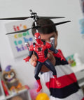 Child holding Spider Man Infrared RC Helicopter Jetpack Flying Figure With LED Lights Twin Rotors Action Phrases Marvel Licensed Toy