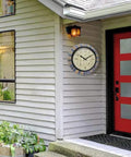Inca II 18 Inch Outdoor Clock Thermometer Weather Station Combo with faux stone mosaic frame installed beside a red door