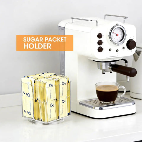 No Sweat Spin Lazy Susan Drink Packet Organizer Square Four Compartment Pantry Turntable For Water Flavor Drinks Sugar Packets Honey Sticks And Tea Bags Kitchen Countertop with sugar packets next to coffee machine.