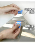Close-up of hands peeling backing from Very Light Window Film With High Heat Rejection And UV Cut 36 Inch By 14 Foot Roll Durable Scratch Resistant Tint