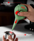 Green Dope Bird Inspired Coffee Air Blower Air Duster for Espresso Machines being used on metal component
