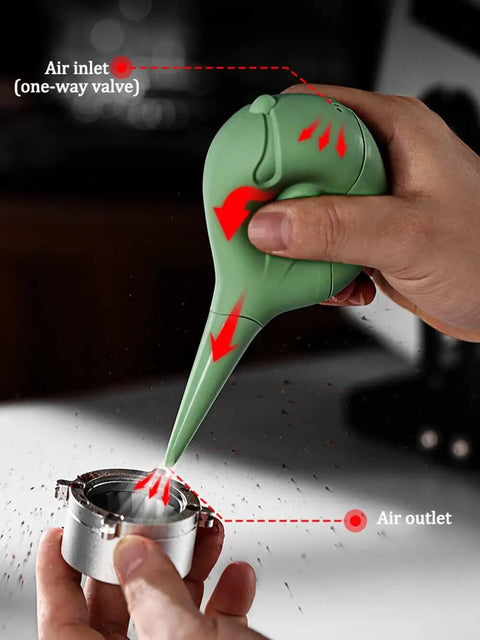 Green Dope Bird Inspired Coffee Air Blower Air Duster for Espresso Machines being used on metal component
