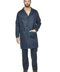 Model wearing Flame Resistant Medical Lab Coat With Concealed Snap Front Adjustable Hem Snap Closure And Four Pockets For Tools Navy Color X Large US Size Durable FR Workwear For Hospital Clinic And Lab Environments