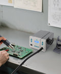 Person using a Powerful 1000W Digital Hot Air Rework Station With LCD Display And 212 To 932 Fahrenheit Temperature Range for PCB repair