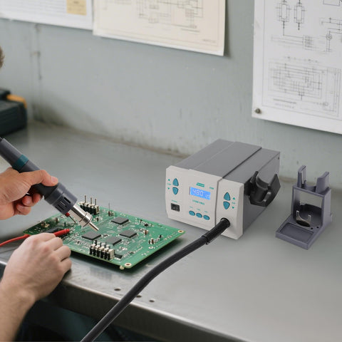 Person using a Powerful 1000W Digital Hot Air Rework Station With LCD Display And 212 To 932 Fahrenheit Temperature Range for PCB repair