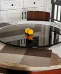 Round Black Rotating Glass Lazy Susan Turntable For Dining Tables 60 To 100 Cm Easy To Clean Serving Tray on table with oranges