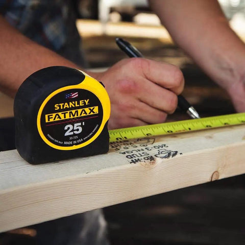 FatMax 25 Foot Tape Measure Set Yellow Four Total, Two Per Pack, Durable Auto Lock Blade, High Visibility Case on wood