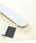 Non Slip Deck Covering For Skateboard And Kick Scooter Waterproof PVC Grip Tape beside skateboard deck on light background