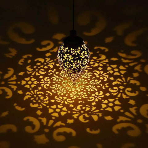 Olive Shaped Hanging Solar Lantern With LED Garden Lights casting patterns on wall, Weatherproof Metal Lamp for Outdoor Patio Decor
