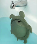 Silicone Turtle Bathtub Overflow Drain Cover In Sea Grass Green adds inches to soak depth, showing turtle design in water.