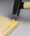 Sunny Biscuit Connector For Size 20 Slide In Wood Joiner with yellow locking tab being hammered into wood for tight joints