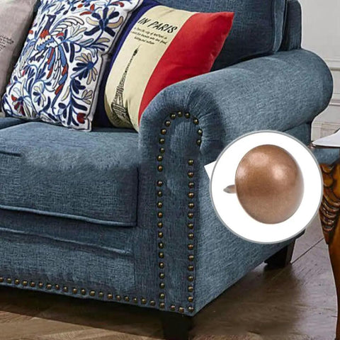 Hella Sturdy Gold Upholstery Tacks 100 Pack Set For Furniture Nailhead Decorative Trim on a blue sofa arm.
