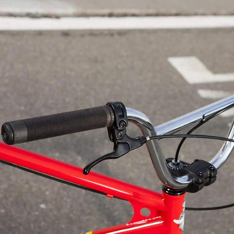 Close-up of red bike handlebar with brake lever, featuring All In One Universal Bike Cable Replacement Kit for Shifting and Braking.