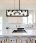 Boss Level Farmhouse Linear Chandelier With Textured Seedy Glass Shades above kitchen island, matte black finish