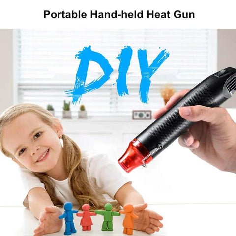 Mini Heat Gun For DIY Projects, Quick Embossing, Shrink Wrap, Paint Drying, And More held by a person near a child with crafts