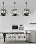Black Globe Pendant Lights With Six Lights in modern kitchen setting, featuring adjustable industrial-style chandeliers.