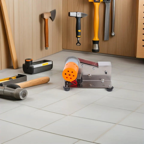 Plug And Play Mini Electric Belt Sander With Twenty Emery Belts Heavy Duty Desktop Grinder in a workshop setting among tools.