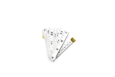 Soft Tape Measure With Dual Scale 60 Inch Vinyl Ruler For Sewing Tailor And Body Measurements, coiled on white background.