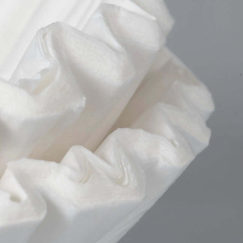 Close-up of paper coffee filters for Commercial Tea And Paper Coffee Filters 1.5 Gallon White 500 Count For Use With Specialty Commercial Brewers.
