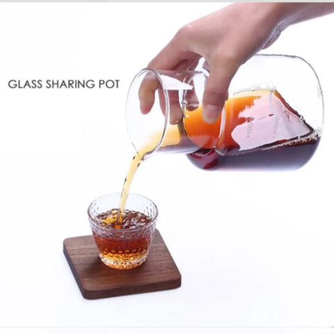 Top Shelf Cold Brew Drip Tower And Iced Coffee Maker With 21 Oz Detachable Borosilicate Carafe pouring coffee into a glass.