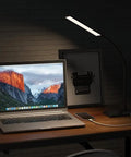 Dope LED Desk Lamp With USB Charging Port illuminating a desk with laptop, Eye-Caring Light for Dorm, Office, and Bedroom.